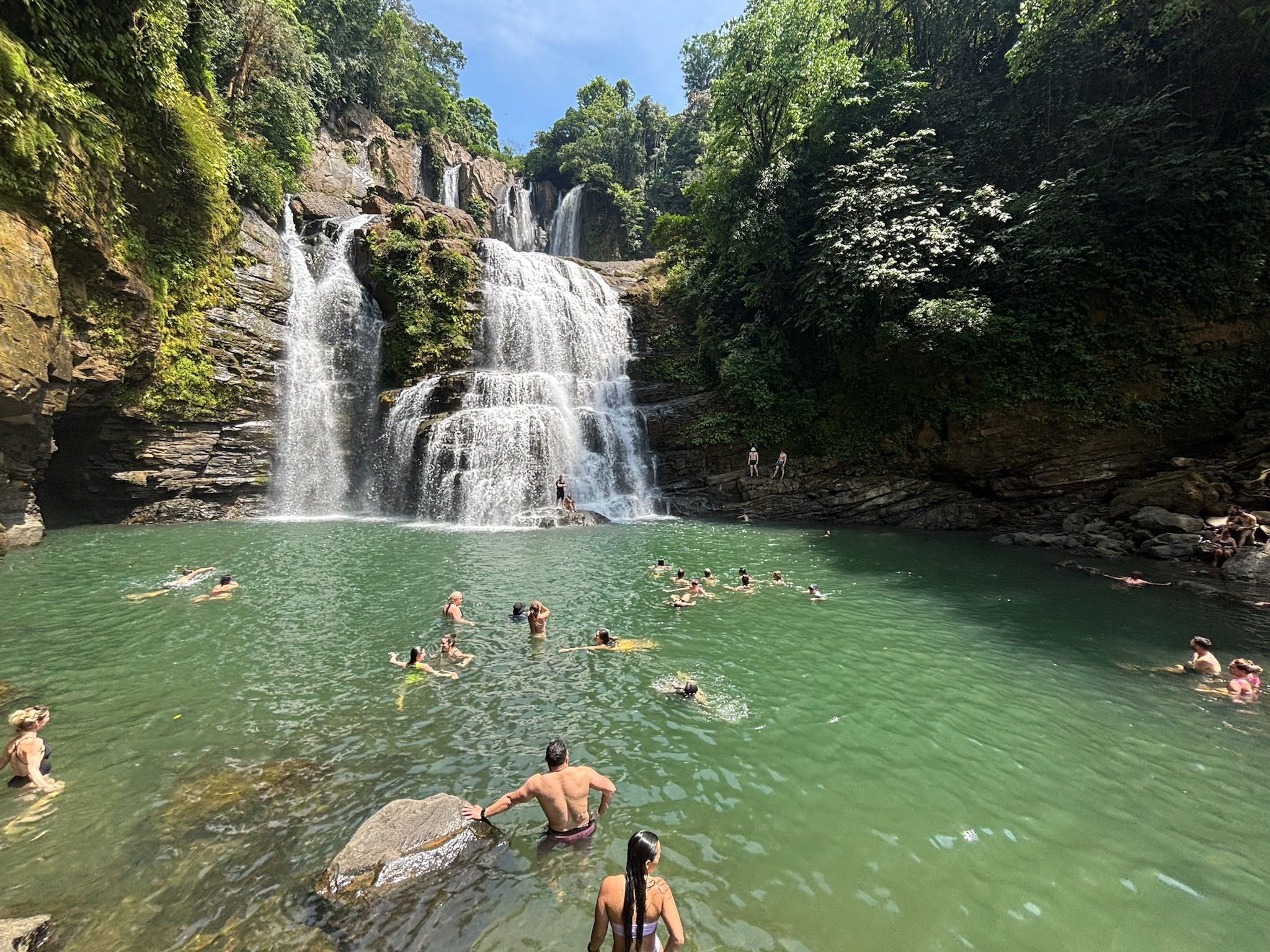Guest taking a swim below the Nauyaca Waterfall, which is nearby to Vajra Jahra's luxury retreat space.
