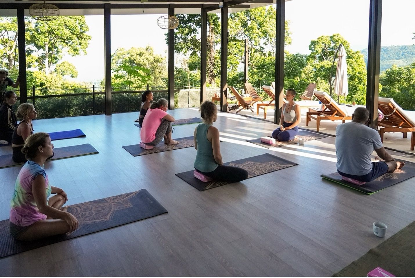 A yoga class in a rainforest yoga shala.